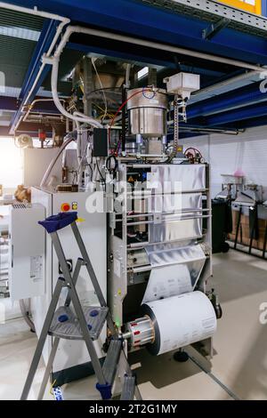 Modern industrial coffee packaging machine. Stock Photo