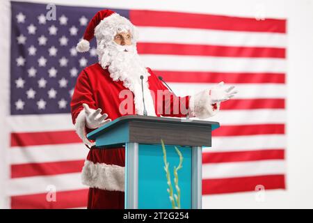 Santa claus giving a speech on a pedestal in front of a USA flag Stock Photo