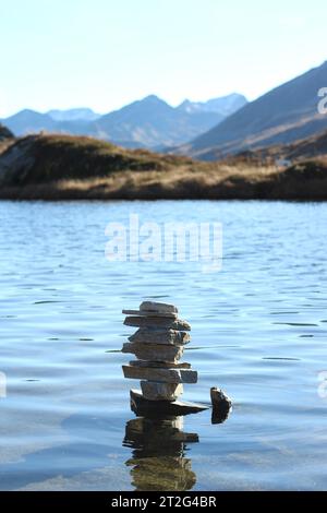 Passo San Bernardino, Switzerland. A tower stone inside the lake at the top of the alpine pass. Stock Photo