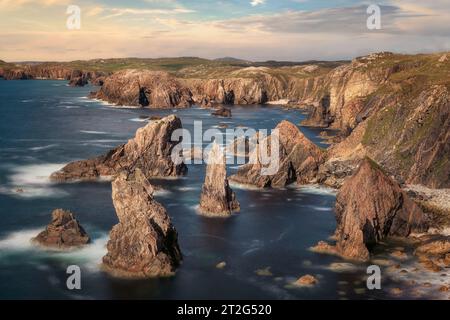 The Mangersta sea stacks are a series of towering natural rock formations that rise out of the Atlantic Ocean off the coast of the Isle of Lewis, Scot Stock Photo