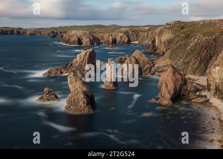 The Mangersta sea stacks are a series of towering natural rock formations that rise out of the Atlantic Ocean off the coast of the Isle of Lewis, Scot Stock Photo