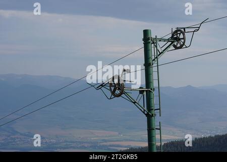 Pole of a ski lift out of service in summer in Little Fatra in Slovakia close up. On the background there are mountains. Stock Photo