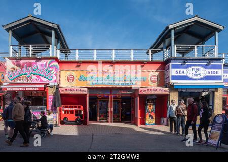 Southsea Island Leisure amusement arcade, with takeaway fish and chips and doughnuts either side, Portsmouth, Hampshire, England, UK Stock Photo