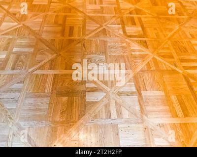 Texture of brown textured yellow wooden floor, parquet of small rectangular plates, lacquered wood plank boards. The background. Stock Photo