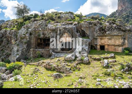 Rock tombs at Pinara ancient site in Mugla province of Turkey. The rock tombs date to about 4th century BC. Pinara was a large city of ancient Lycia. Stock Photo