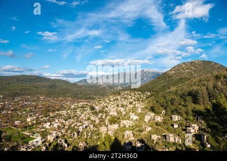 View over the ruined houses of Kayakoy (Levissi) abandoned village near Fethiye in Mugla province of Turkey. Levissi was deserted by its mostly Greek Stock Photo