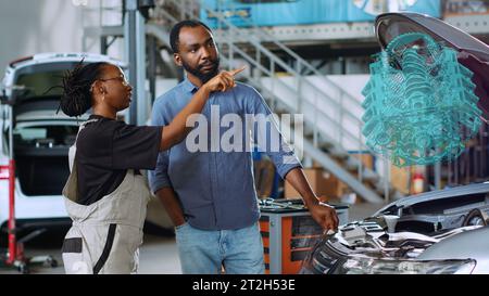 Serviceman repairing a car using augmented reality application Stock ...