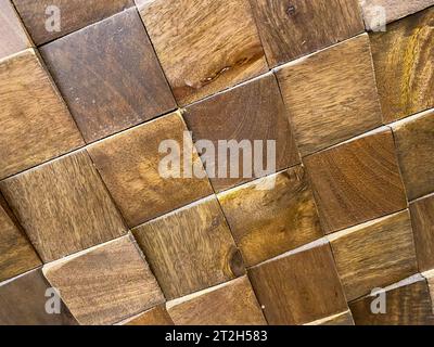 A beautiful brown surface made from many small wooden raised volumetric squares. Background, texture. Stock Photo