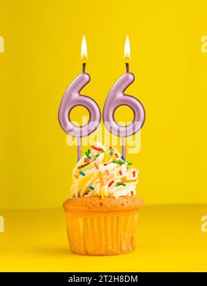 Number 66 candle - Birthday card design in yellow background Stock Photo