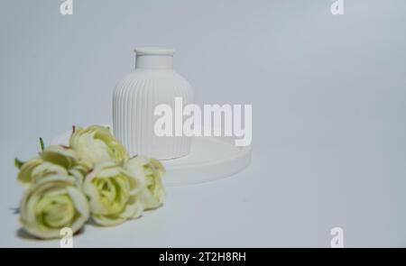 Small white ceramic vase.handmade symbolic ceramic figurines with flower Stock Photo