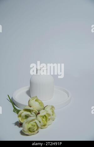 Small white ceramic vase.handmade symbolic ceramic figurines with flower Stock Photo