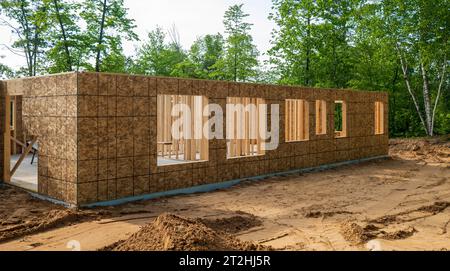 New home construction site in early stage, with exterior walls and openings for future window. Stock Photo