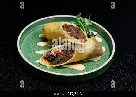 crispy fried duck or chicken spring rolls with black background Stock Photo