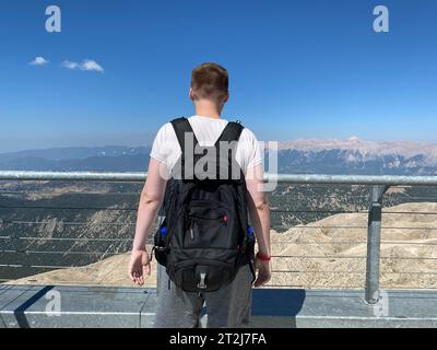 Chile, Chaiten, Parque Pumalin, man standing on observation deck looking at glacier. Stock Photo