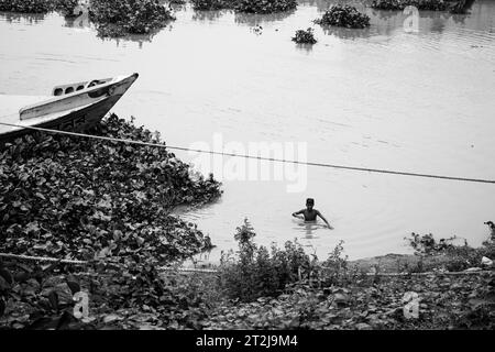 Gabtoli Amen Bazar is a bustling traditional boat station in Dhaka, Bangladesh, image captured on May 29, 2022. Boats line the tranquil waters of the Stock Photo