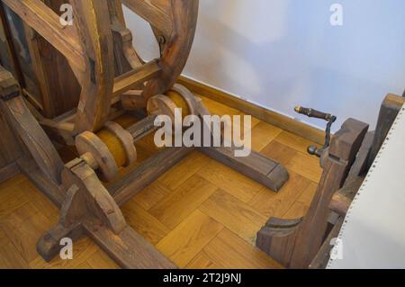 Old ancient medieval wooden mechanism, machine with gears and handles. Stock Photo