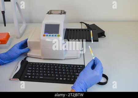 Scientist chemist holding ph test in his hands closeup. Stock Photo