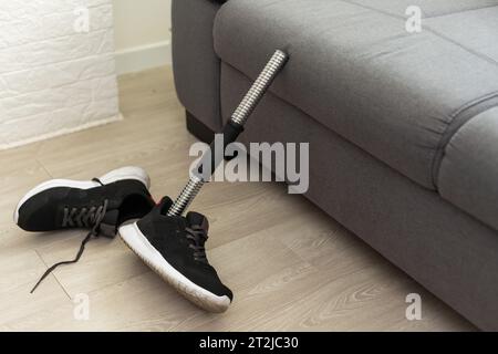 High angle background of disassembled prosthetic leg and foot on table in orthopedic equipment shop, disability concept Stock Photo