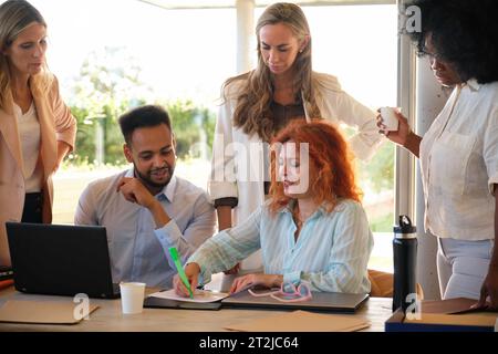 Group of multiethnic business people and software developers working as a team in office. Stock Photo