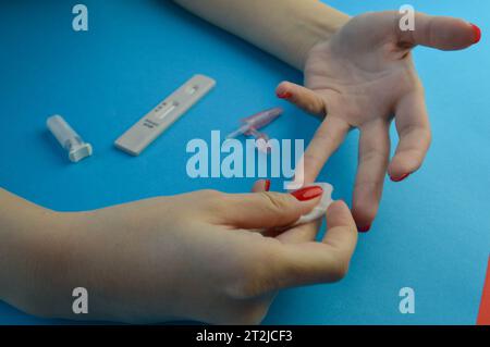collection of capillary blood from a finger. after analysis, rub the finger with alcohol to stop bleeding. analysis in the laboratory to identify path Stock Photo