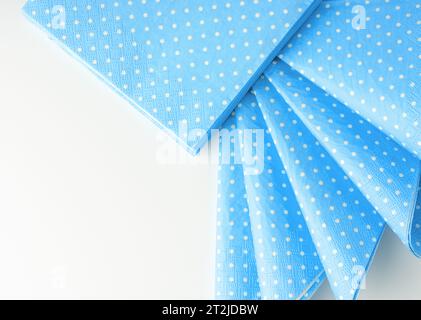 Stack of blue dotted paper napkins isolated on white Stock Photo