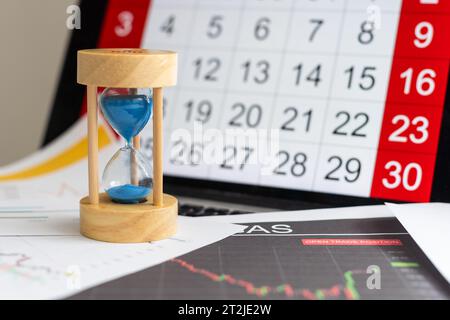 Hour glass and calendar concept for time slipping away for important appointment date, schedule and deadline Stock Photo