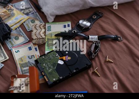 Money and weapons in crime lab for investigation, conceptual image Stock Photo