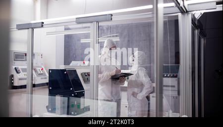Factory Clean Room Laboratory. Industrial Engineer Using Technology Stock Photo