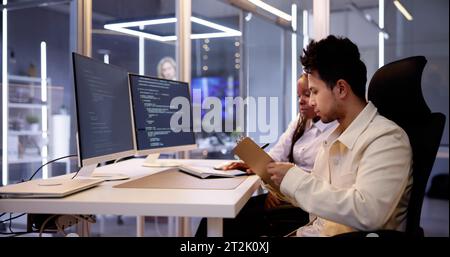 Computer Programmer Writing Program Code On Computer In Office Stock Photo