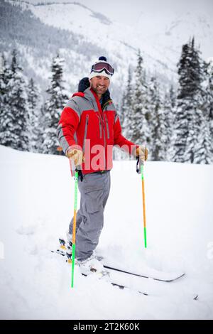 A well-known skier and judge of ski competitions, Jim Jack, stands in fresh powder. Jim was caught in an avalanche in 2012 and was killed in the back country with 3 other skiers. Stock Photo