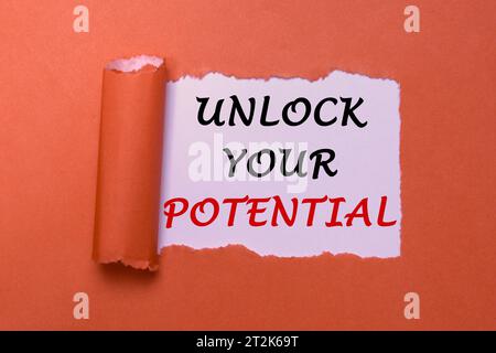 Unlock Your Potential Concept. Empowering Message on Torn Red Paper. Inspirational Motivation for Personal Growth and Success/ Stock Photo