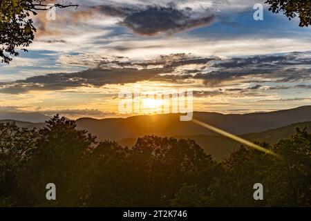 The Sun Sets Through the Clouds over the Blue Ridge Mountains Stock Photo