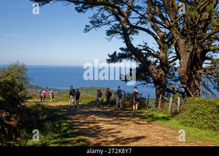 JAIZKIBEL, SPAIN, September 24, 2023 : Pilgrims on the way to Santiago de Compostella by Camino del Norte (North path) along the atlantic coast. Stock Photo