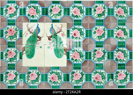 Rows of antique Nyonya Tiles with pink flowers and peacocks. Vintage wall tile in penang. Stock Photo