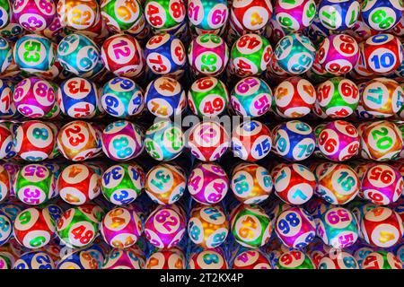 Many multi-colored lottery balls with numbers in a row. 3d rendering Stock Photo