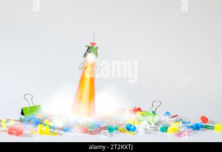 thinking outside the box, idea,start up,innovation, human resources business concept with heap of office supplies, a paper clamp and a push pin transf Stock Photo