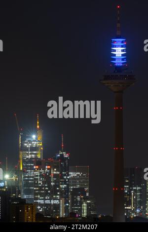 As a sign of solidarity with Israel, the top of the Europaturm (Ginnheimer Spargel) in Frankfurt am Main lights up in the evening in Israel's Stock Photo