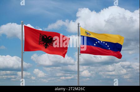 Venezuela and Albania flags waving together in the wind on blue cloudy ...