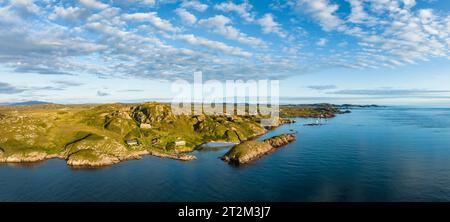 Aerial panorama of the coastline of the Ross of Mull peninsula and the fishing village of Fionnphort on the right, Torr Mor granite quarry closed Stock Photo