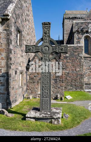The Christian Iona Abbey, pilgrimage destination, Iona Monastery with the reconstructed Celtic Cross of St Johns on the Scottish Hebridean island of Stock Photo