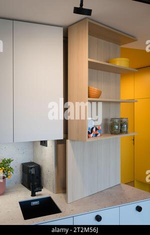 Custom kitchen cabinet with hidden circuit breaker box in small urban apartment Stock Photo