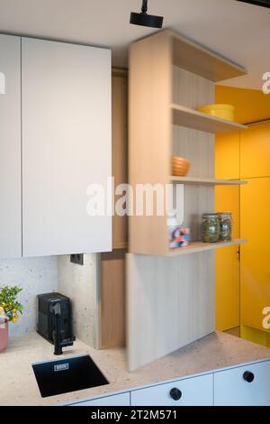 Custom kitchen cabinet with hidden circuit breaker box in small urban apartment Stock Photo