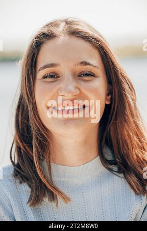 Portrait of happy young brunette woman with wavy brown medium hairstyle, waves with side volume. High quality photo Stock Photo