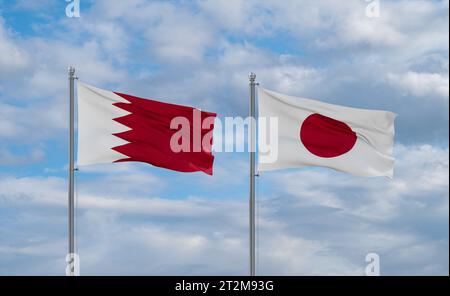 Japan and Bahrain flags waving together on blue cloudy sky, two country relationship concept Stock Photo