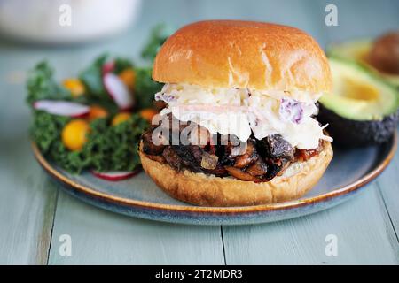 Vegan and vegetarian pulled portobello mushroom burger with slaw. Made with mushrooms, onions, and homemade bbq sauce on a fresh brioche bun. Stock Photo