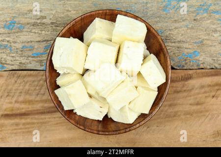 Paneer sliced in a wooden bowl top view Stock Photo