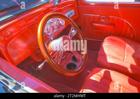 red interior classic car selective focus on steering wheel Stock Photo