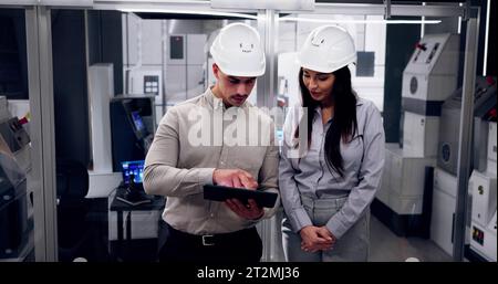 Factory Engineers In Helmets. Checking Industrial Facility Stock Photo