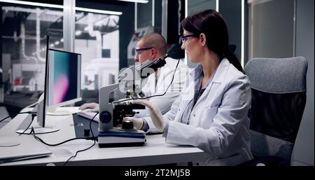 Electronic Lab Factory Worker And Semiconductor Engineer Testing Device Stock Photo