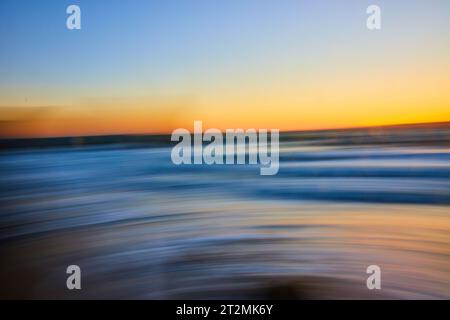 Motion blur of sunset over blue ocean near dusk abstract background asset Stock Photo